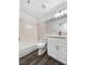 Modern bathroom featuring wood-look floors, bathtub, and vanity with sink at 2306 Jared Ct, North Las Vegas, NV 89032