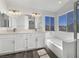 Elegant bathroom with double vanity, soaking tub, and a separate glass-enclosed shower at 2306 Jared Ct, North Las Vegas, NV 89032