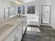 A spa-like bathroom featuring double sinks, a soaking tub, and a glass-enclosed shower at 2306 Jared Ct, North Las Vegas, NV 89032