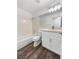 Modern bathroom featuring wood-look floors, bathtub, and vanity with sink at 2306 Jared Ct, North Las Vegas, NV 89032
