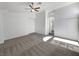 Spacious carpeted bedroom with a ceiling fan, white walls, and access to an ensuite bathroom at 2306 Jared Ct, North Las Vegas, NV 89032