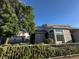 Side view of a stucco home, showing a sun room with a large window and a partial view of the fenced yard at 2306 Jared Ct, North Las Vegas, NV 89032