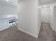 Bright hallway showcasing carpeted floors and a white railing overlooking below at 2306 Jared Ct, North Las Vegas, NV 89032