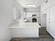 Modern kitchen features white cabinets, quartz countertops, and stainless steel appliances at 2306 Jared Ct, North Las Vegas, NV 89032
