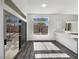 Bright dining area with wood-look floors, large windows, and a breakfast bar with quartz countertop at 2306 Jared Ct, North Las Vegas, NV 89032