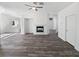 Open-concept living room with fireplace, ceiling fan, and wood-look flooring at 2306 Jared Ct, North Las Vegas, NV 89032