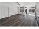 Spacious living area featuring a ceiling fan, a fireplace, and modern wood-look floors at 2306 Jared Ct, North Las Vegas, NV 89032