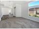 Inviting living room with a view into the kitchen and large bright windows at 2306 Jared Ct, North Las Vegas, NV 89032