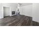 Open living space showcasing a tiled fireplace, staircase, fresh paint, and wood-look floors at 2306 Jared Ct, North Las Vegas, NV 89032