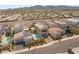 Aerial view showcases a home with a pool, landscaping, solar panels, and neighborhood at 2578 Skylark Trail St, Henderson, NV 89044