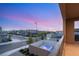Balcony view of neighborhood pool and landscaping at dusk under a colorful sky at 2578 Skylark Trail St, Henderson, NV 89044