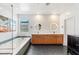 Bright bathroom featuring double vanity, soaking tub, and modern fixtures at 2578 Skylark Trail St, Henderson, NV 89044