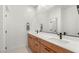 Modern bathroom with double sinks, sleek fixtures, and wood-finished cabinets at 2578 Skylark Trail St, Henderson, NV 89044