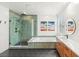 Modern bathroom featuring dual shower heads, glass doors, soaking tub and vanity with illuminated mirror at 2578 Skylark Trail St, Henderson, NV 89044