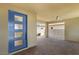 Inviting covered entrance featuring a blue modern door, brick flooring, ceiling fan, and open access to the backyard at 2578 Skylark Trail St, Henderson, NV 89044