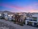 Exterior shot of a modern home with clean lines, contrasting colors, and professional landscaping, set against a mountain backdrop at 2578 Skylark Trail St, Henderson, NV 89044