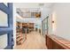 Bright foyer with a modern staircase, hardwood floors, high ceilings, and an open view of the kitchen and living areas at 2578 Skylark Trail St, Henderson, NV 89044