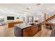 Spacious kitchen with a large island, modern lighting, hardwood floors, and open to the living and dining areas at 2578 Skylark Trail St, Henderson, NV 89044