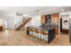 Open-concept kitchen with a large island, modern appliances, stylish lighting, and hardwood floors connecting to the living area at 2578 Skylark Trail St, Henderson, NV 89044