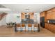 Modern kitchen featuring a large island with seating, stainless steel appliances, sleek cabinetry, and hardwood floors at 2578 Skylark Trail St, Henderson, NV 89044