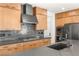 Close up of kitchen with stainless steel appliances and a dark backsplash and countertops at 2578 Skylark Trail St, Henderson, NV 89044