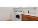 Modern laundry room with washer, dryer, sink, and shaker cabinets at 2578 Skylark Trail St, Henderson, NV 89044