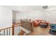 Cozy loft with comfortable orange sofa, stylish ottoman, and views of the staircase below at 2578 Skylark Trail St, Henderson, NV 89044