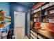 Well-organized pantry with dark cabinets and open shelving, plus stylish wallpaper at 2578 Skylark Trail St, Henderson, NV 89044