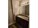 Simple bathroom featuring a vanity with granite countertop and a large mirror at 2606 S Durango Dr # 214, Las Vegas, NV 89117