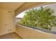 Cozy covered balcony offering a view of lush tree and neighboring buildings at 2725 S Nellis Blvd # 2049, Las Vegas, NV 89121