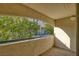 View from balcony with neutral-colored wall, with a view of a treed courtyard at 2725 S Nellis Blvd # 2049, Las Vegas, NV 89121