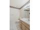 Cozy bathroom featuring a vanity with cabinet storage, floral wallpaper, and tiled floors at 2725 S Nellis Blvd # 2049, Las Vegas, NV 89121