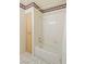Bathroom featuring a shower-tub combination with white tiled walls and built-in storage at 2725 S Nellis Blvd # 2049, Las Vegas, NV 89121
