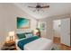 Staged bedroom with wood floors, ceiling fan, and view into walk-in closet at 2725 S Nellis Blvd # 2049, Las Vegas, NV 89121