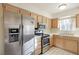 Well-lit kitchen showcasing stainless steel refrigerator, microwave, and tile countertops at 2725 S Nellis Blvd # 2049, Las Vegas, NV 89121