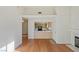 Living room view with hardwood floors, open floorplan, fireplace, and view into the kitchen at 2725 S Nellis Blvd # 2049, Las Vegas, NV 89121
