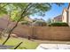 A backyard featuring low-maintenance landscaping, mature trees, and beautiful mountain views at 305 Napa Hills Dr, Las Vegas, NV 89144