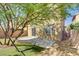 A backyard featuring low-maintenance landscaping, mature trees, a patio, and a hammock at 305 Napa Hills Dr, Las Vegas, NV 89144