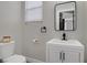 Bathroom featuring a white vanity with a black faucet and a framed mirror at 305 Napa Hills Dr, Las Vegas, NV 89144