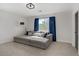 Comfortable bedroom features a large sectional couch and plenty of natural light from the large window at 305 Napa Hills Dr, Las Vegas, NV 89144