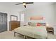 Well-lit bedroom with a wooden dresser, neutral tones, and a ceiling fan at 305 Napa Hills Dr, Las Vegas, NV 89144
