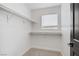 Walk-in closet features shelving and a window for natural light at 305 Napa Hills Dr, Las Vegas, NV 89144