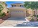 Beautiful home with a two-car garage and a well-manicured front yard at 305 Napa Hills Dr, Las Vegas, NV 89144
