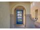Inviting entryway with a modern blue door and decorative archway at 305 Napa Hills Dr, Las Vegas, NV 89144