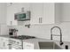 Close up on stove with stainless steel appliances, gray countertop, and white subway tile backsplash at 305 Napa Hills Dr, Las Vegas, NV 89144