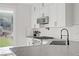 Bright kitchen with stainless steel appliances, gas range, and views of the backyard at 305 Napa Hills Dr, Las Vegas, NV 89144