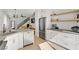 Open floor plan kitchen with stainless steel appliances, white cabinets and floating shelves at 305 Napa Hills Dr, Las Vegas, NV 89144