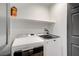 Laundry room with white appliances, a shelf, and gray trim at 305 Napa Hills Dr, Las Vegas, NV 89144