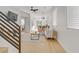 Bright, modern living room with sleek furniture, hardwood floors, and a staircase at 305 Napa Hills Dr, Las Vegas, NV 89144