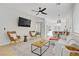 Open-concept living room featuring a ceiling fan, modern furniture, and natural light at 305 Napa Hills Dr, Las Vegas, NV 89144